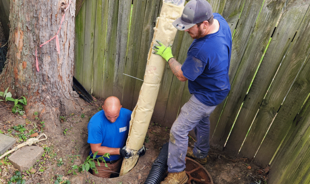 Workers installing a pipe system in a residential digging operation.