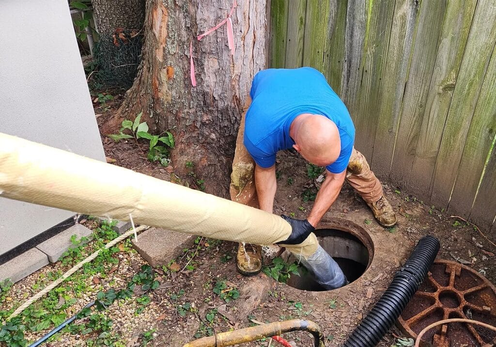 Homeowner using effective techniques to clean a clogged drain.