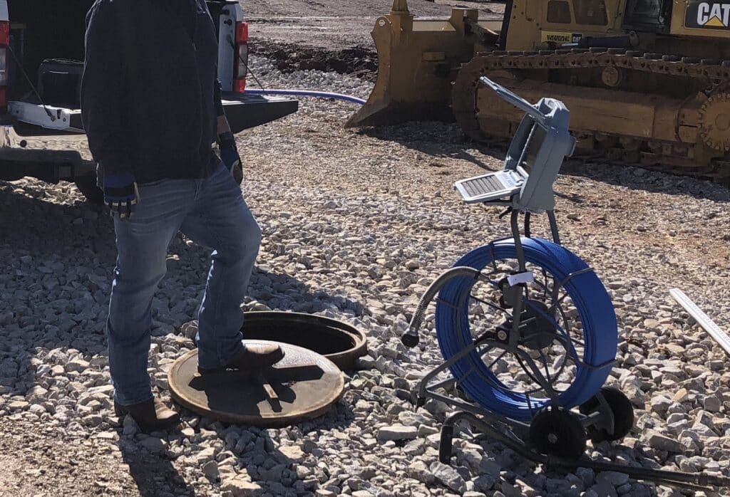 Manhole inspection tools and equipment set up for efficient underground assessment.