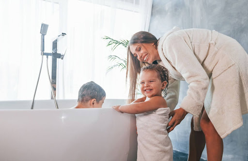 Family bath time with kids enjoying a fun and playful experience together.