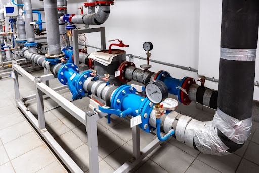 Industrial piping system with valves and gauges in a mechanical installation.