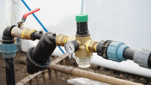Water pressure valve with gauge for efficient plumbing and irrigation system management.