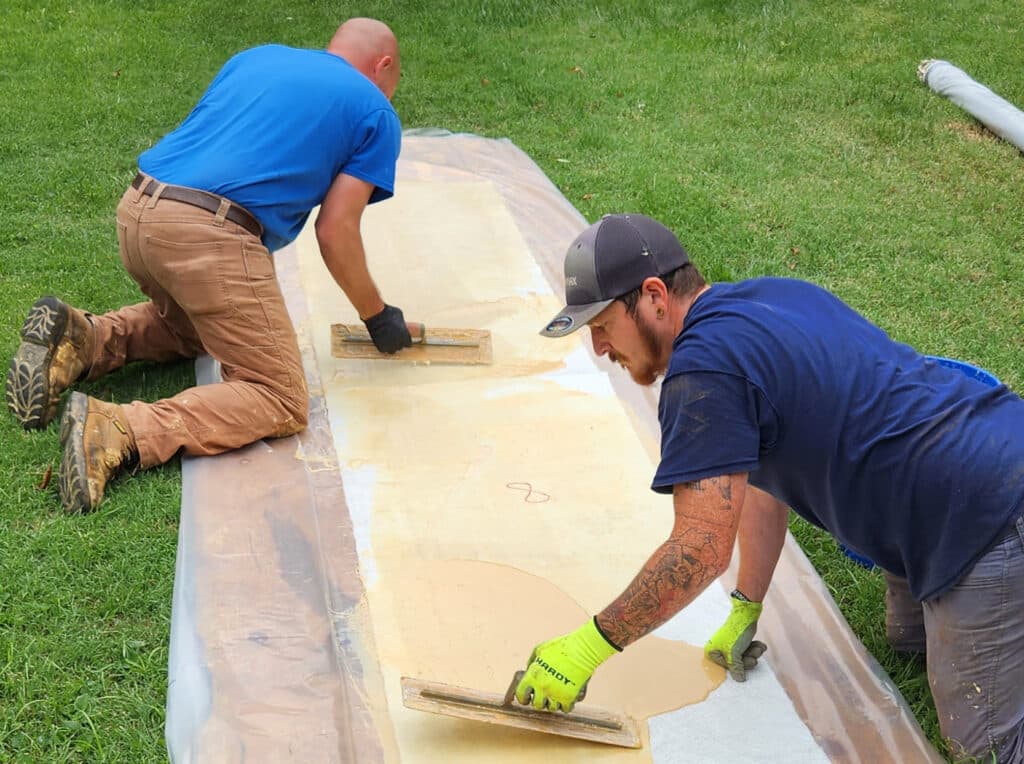 Pipe lining workers apply materials on the site for installation and repair projects.
