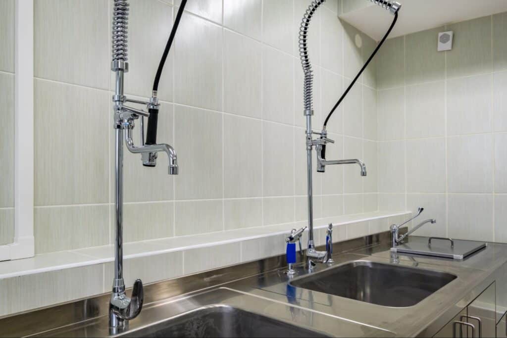 High-efficiency commercial kitchen sinks with modern faucets for optimal functionality.