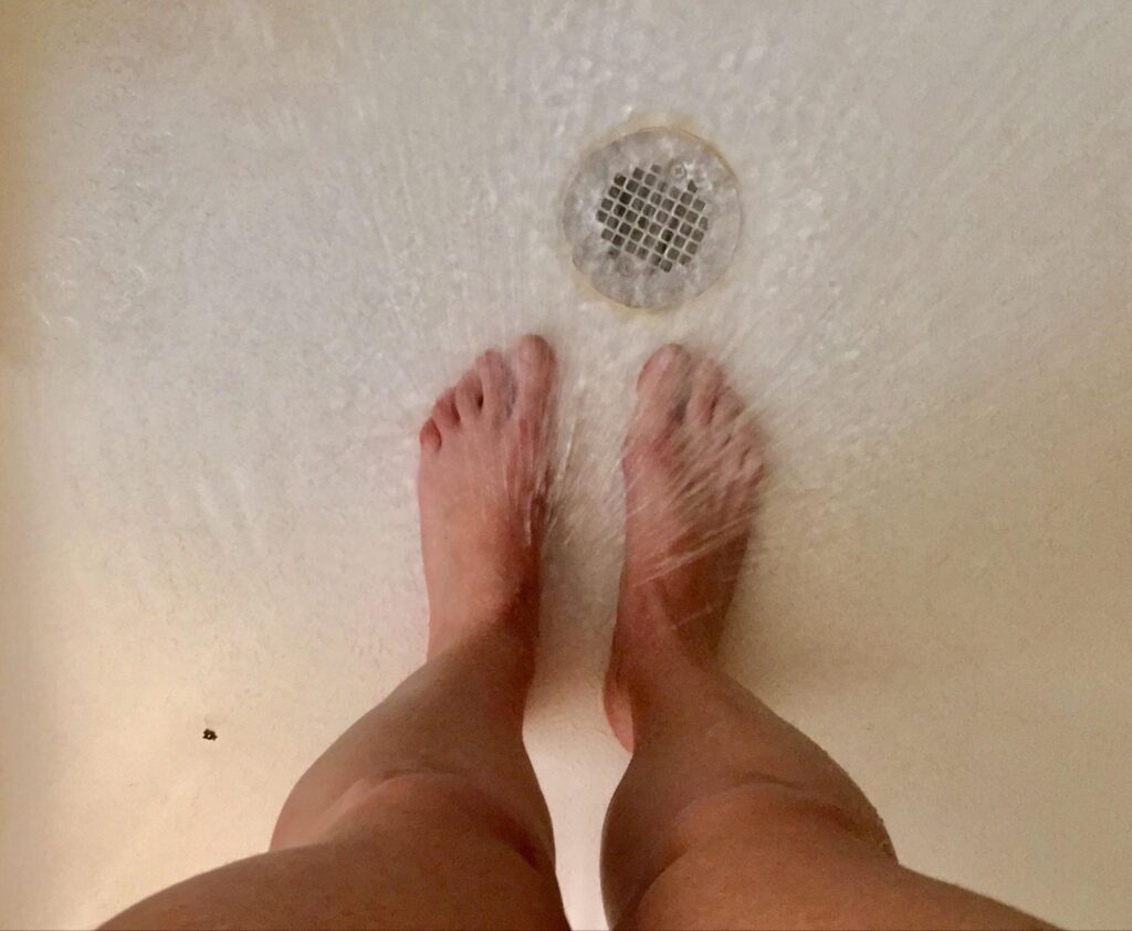 Relaxing feet under the soothing flow of a gentle shower.