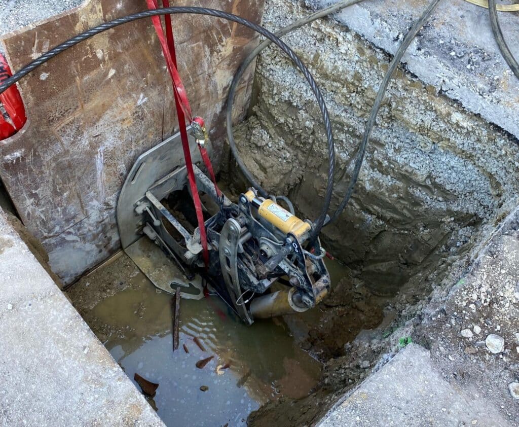 Underwater excavation equipment operating in a construction site trench.