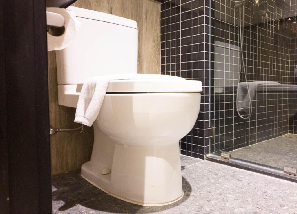 Sleek white toilet in a stylish modern bathroom with elegant tile accents.