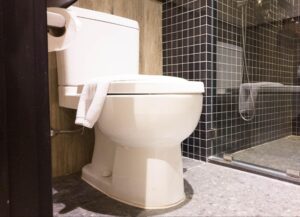 Sleek white toilet in a stylish modern bathroom with elegant tile accents.