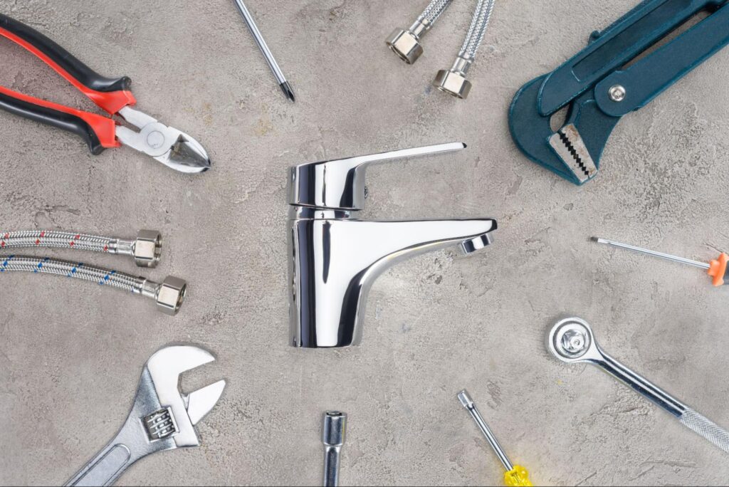 Plumbing tools and a faucet for efficient repair and installation.